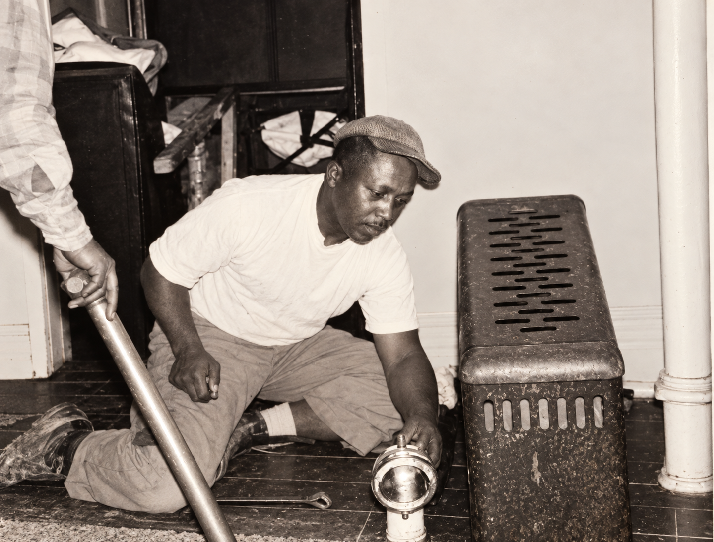 Charles Busby Sr. working as a plumber, part of the early history of Busby's Plumbing